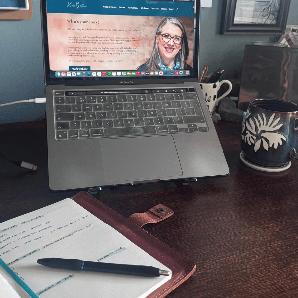 A photo of my desk with my laptop open, a mug and my diary.